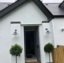 front door with lamps either side